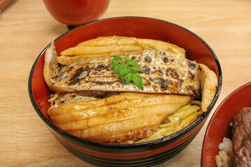 Grilled conger eel rice bowl dish served in red bowl