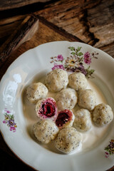 lazy dumplings with poppy seeds and cherry filling with cream sauce