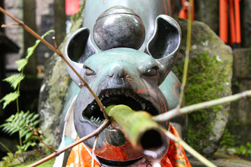 Bronze dragon water fountain with bamboo pipe at Japanese shrine