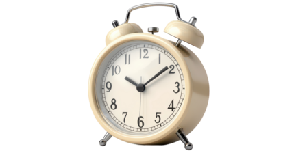 A vintage alarm clock with a cream-colored finish sits on a wooden desk, silently marking the passage of time during a quiet morning