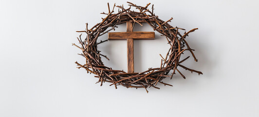 Fototapeta premium Wooden cross inside a crown of thorns on a white background