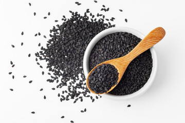 Black sesame seeds in white bowl with wooden spoon isolated on white background