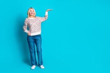 Full body portrait of pretty aged lady measure empty space wear sweater isolated on turquoise color background