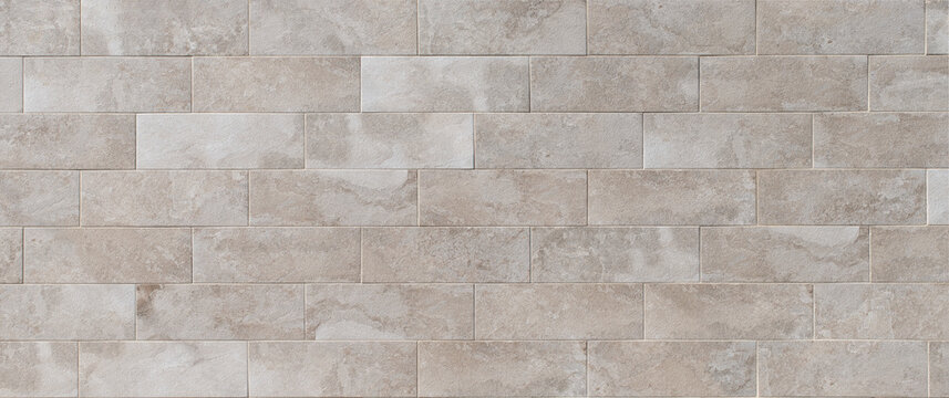 Panoramic texture background of a wall with smooth stone tiles in neutral tones and straight lines