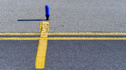 Signal and yellow line marking on airport tarmac