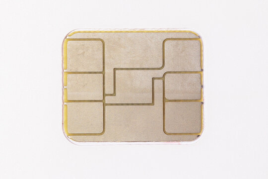 Electronic chip on a white bank card. Identification chip on a plastic card close-up