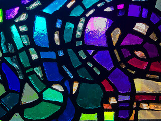 Flowing Stained Glass Window Close-Up with Vibrant Colors and Abstract Design