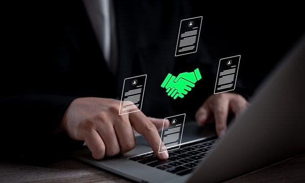 A businessperson reviews and signs a digital contract on a laptop, symbolizing modern agreements, online business transactions, and the shift towards efficient, paperless workflows in digital economy.