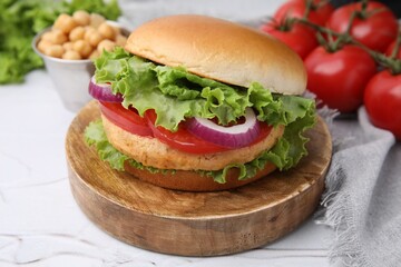 Delicious vegetarian burger with chickpea cutlet on white table, closeup
