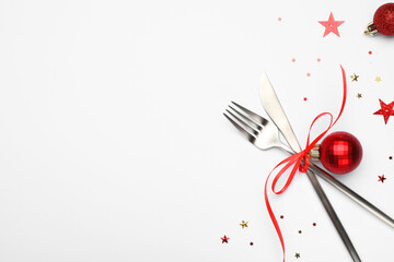 Christmas table setting. Cutlery and festive decor on white background, flat lay. Space for text