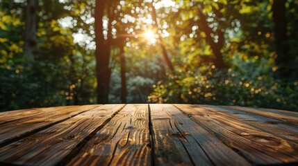 Wooden table top with blurred forest background and sun shining through trees.