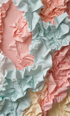 a close-up view of crumpled, pastel-colored fabric, with a mix of pink, blue, and white hues