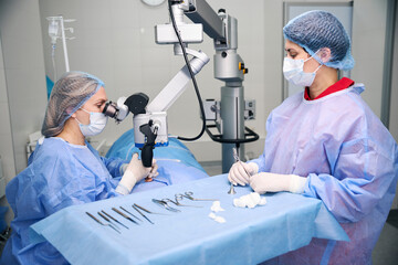 Team of surgeons performs a surgical operation in operating room