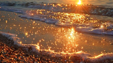 Naklejka premium A wave on a sandy beach at sunrise with the sun reflecting in the water.