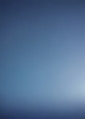 Obraz premium a gradient of blue hues, transitioning from a deep blue at the top to a lighter shade at the bottom The gradient appears to be smooth and continuous, with no discernible