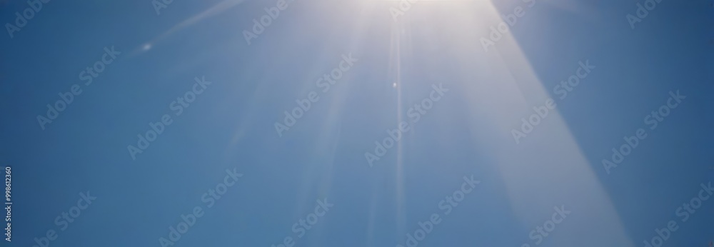 Poster sunlight streams down from the top right corner, casting a warm glow on the clear blue sky