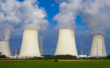 Nuclear power plant on green grass field generated with AI