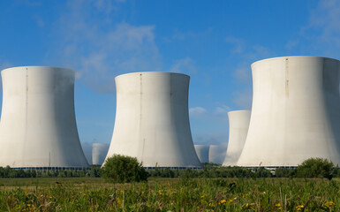 AI-generated nuclear power plant set on a vibrant green grass field
