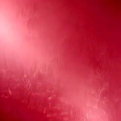 Fototapeta premium a pinkish-red gradient background with a subtle texture, creating a soft and dreamy visual effect