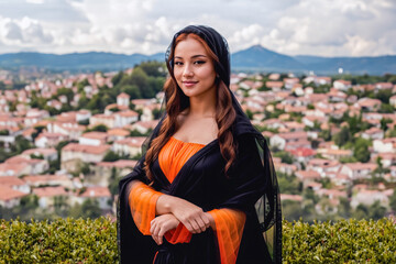 Modern photographic reimagined version of the Mona Lisa portraited in front of a city