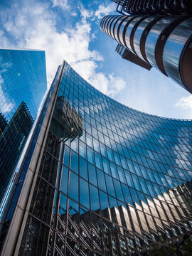 London tall skyscrapers, city office and finance work place. Low perspective and blue tone sky for dynamic mood. 