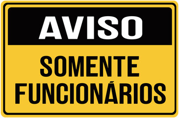 Fototapeta premium A sign in black and yellow color that warns in portuguese language : notice stafgf only