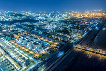 Oil refinery chemical plant industrial equipment buildings at night