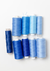 Blue thread spools on white background.