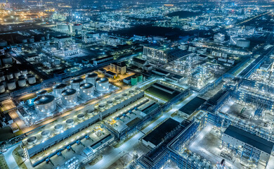 Oil refinery chemical plant industrial equipment buildings at night