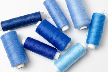 Blue thread spools on white background.