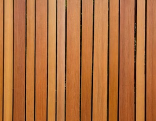 Naklejka premium Close-up polished wooden decking showcasing rich grain patterns and warm tones in natural light