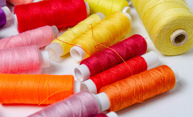 Top view of many colorful thread spools background