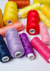 Top view of many colorful thread spools background