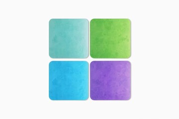 four square coasters with different colors of watercolor paint