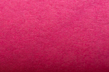 Close-up of natural craft paper texture, showcasing its earthy, raw, and eco-friendly material. Bright magenta colour background.