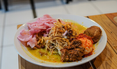 Lontong Medan or Lontong Sayur Medan. Rice cake with tauco, noodle, tempeh, and egg. Traditional cuisine from Medan, North Sumatra, Indonesia. Selective focus