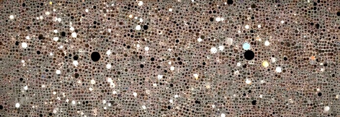 a close-up view textured surface with a pattern of small, irregularly shaped dots in various shades of gray, black, and white