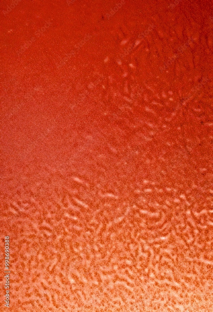 Poster a close-up view textured surface, possibly a glass or metal, with a gradient of colors transitioning
