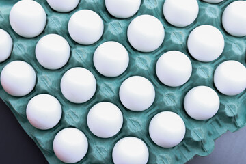 Top view of a carton of white eggs.