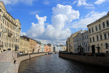 Fototapeta premium A picturesque street view along an embankment with historic buildings in a European city. The calm atmosphere and traditional architecture create a serene urban landscape.