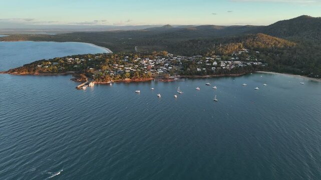 Wide panoramic aerial view over Coles bay and the blue waters of the ocean in Australia.