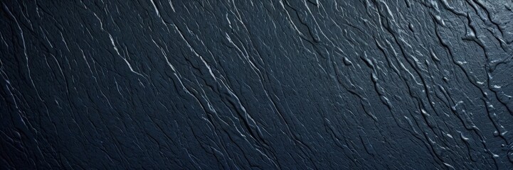 Naklejka premium a close-up view textured surface, likely a dark-colored material, with a diagonal pattern of lines and curves