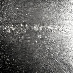 a close-up view textured surface, possibly glass or a frosted window, with a pattern of small white dots or specks scattered across it