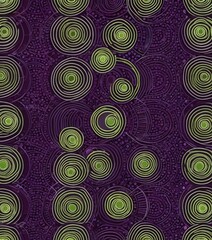 a repeating pattern of concentric circles in shades of green and purple, with a central green circle surrounded by a ring of purple and green circles