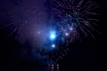 Fireworks, blue night fireworks on black sky background