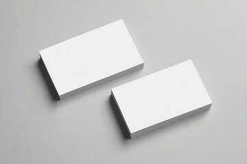 two blank business cards on a gray surface
