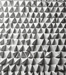 Obraz premium A repeating pattern of white triangles arranged in a grid-like fashion, creating a visually striking geometric design