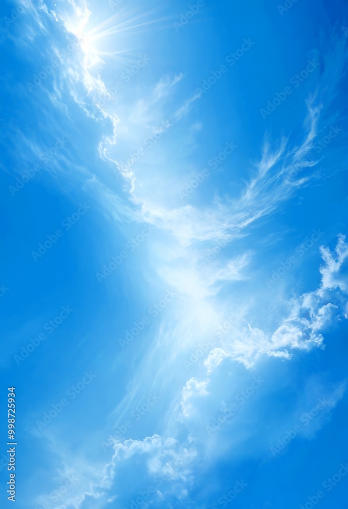 Aufkleber a serene blue sky with fluffy white clouds, where the sun's rays are shining through the top left co