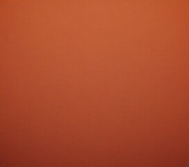 Fototapeta premium a solid orange background with a subtle texture, creating a warm and inviting atmosphere