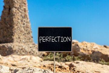 Perfection symbol. Concept word Perfection on beautiful chalk blackboard. Beautiful red stone and blue sky background. Business perfection concept. Copy space.